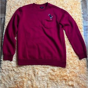 This is a Large red embroidered sweater